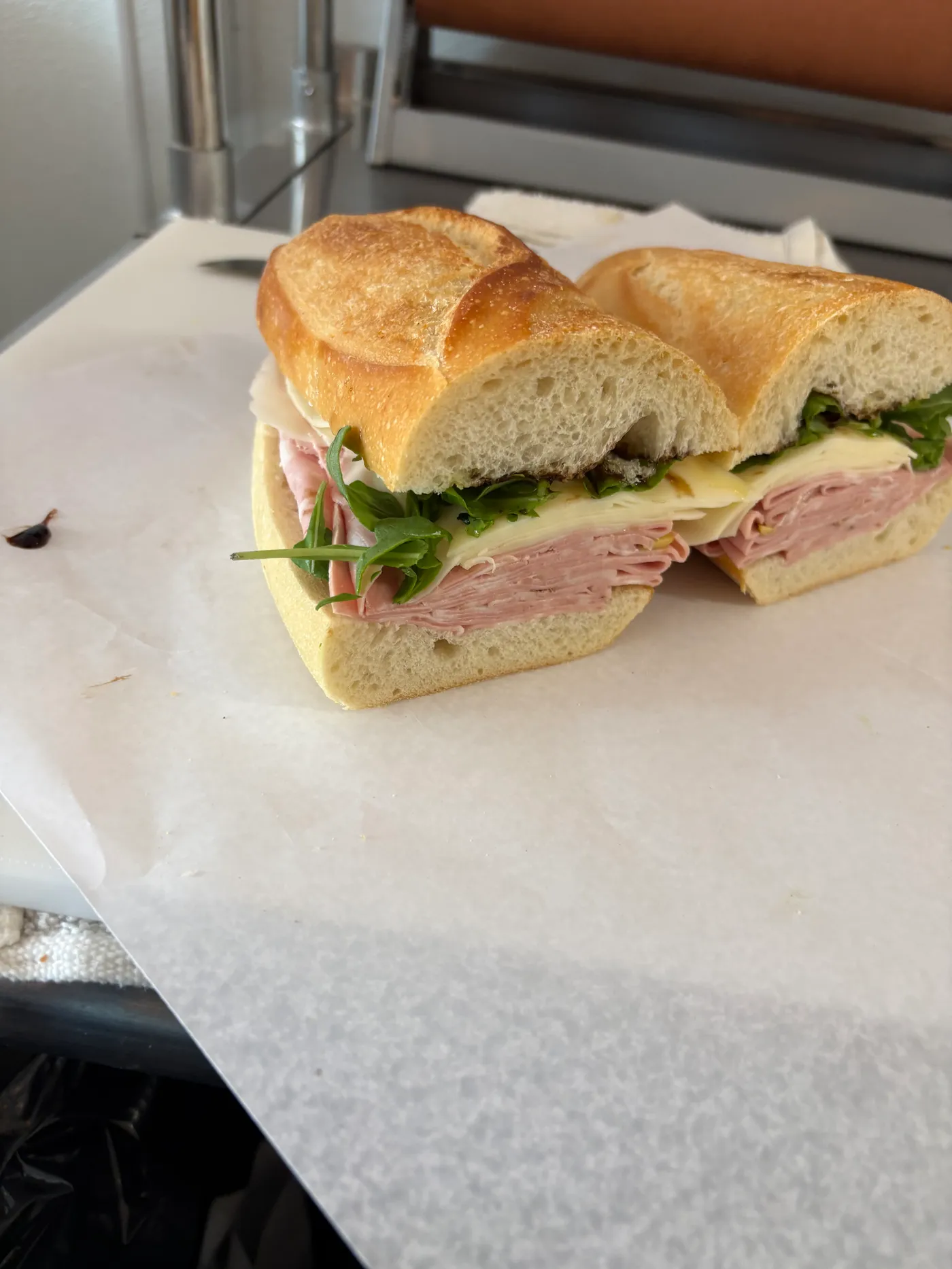 Ham and cheese sandwich with arugula on a fresh roll