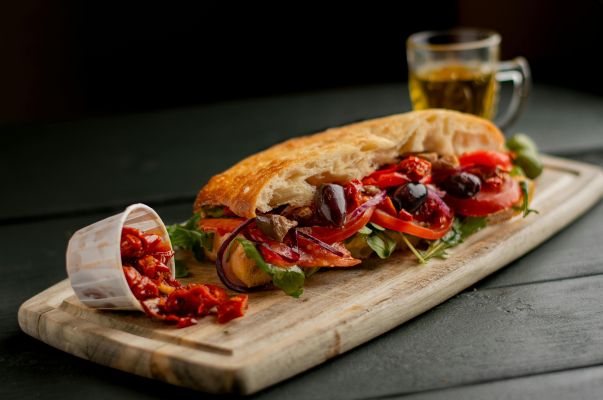 Fresh Italian sandwich with olives and tomatoes in a Manchester cafe.