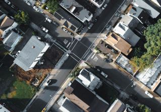 Aerial view of urban intersection in Paterson, NJ with buildings and streets.